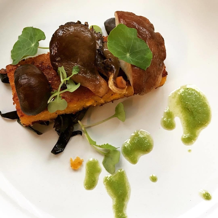 Feast of the Blossom Moon First course: Seared Cornbread - Smoked Forest Mushrooms - Spruce Tip Oil - Nasturtium Leaf